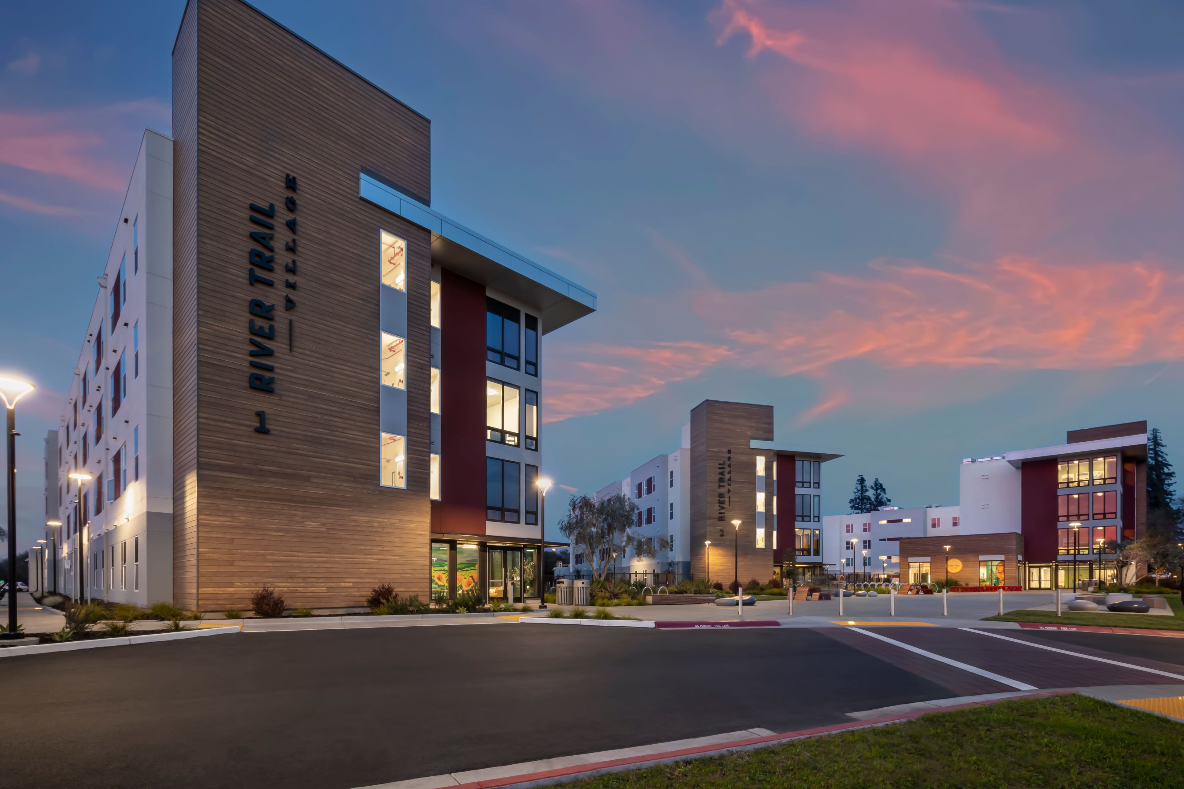 River Trail Village buildings at sunset with the wordmark on the corner tower