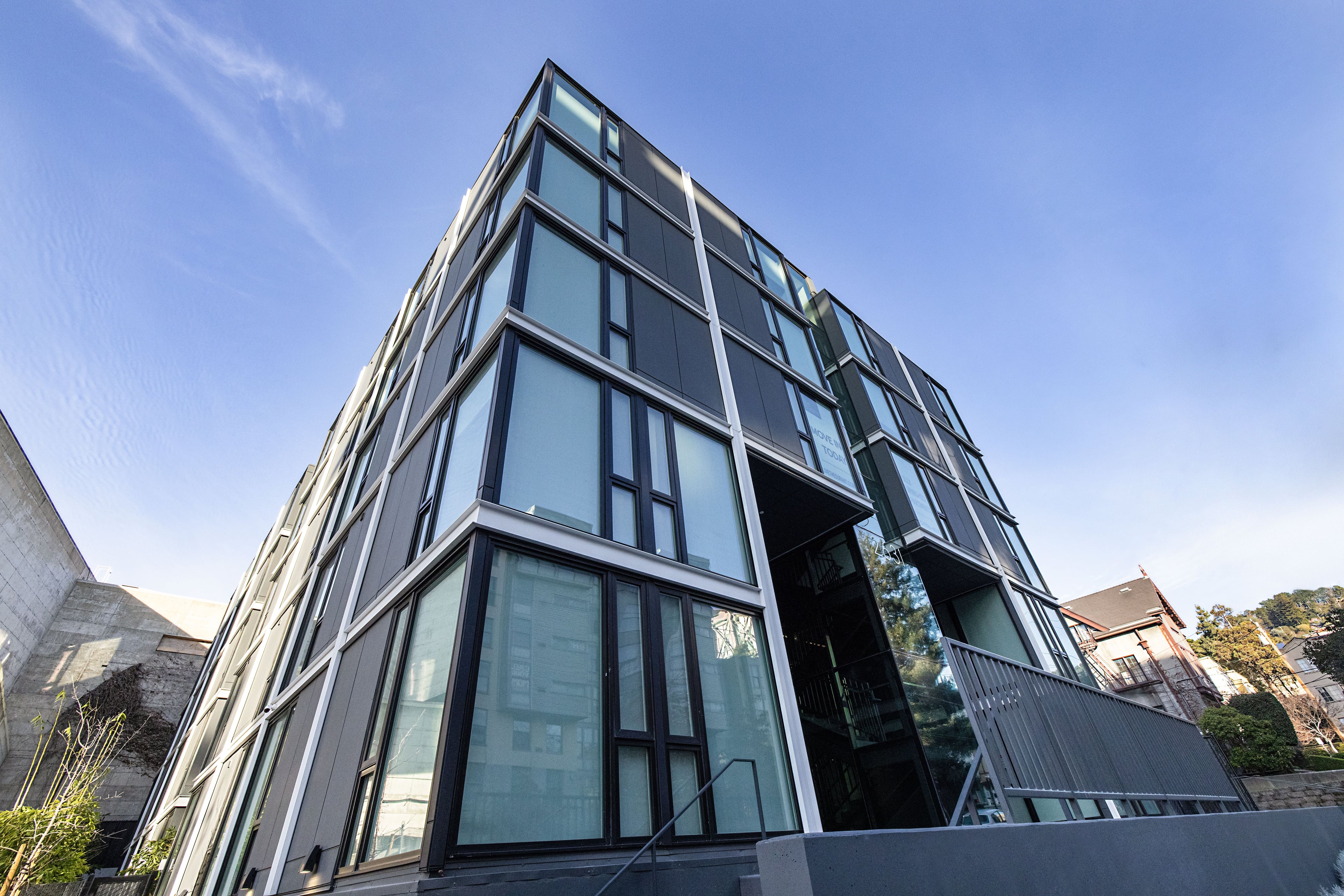 The building’s corner seen from below against a blue sky